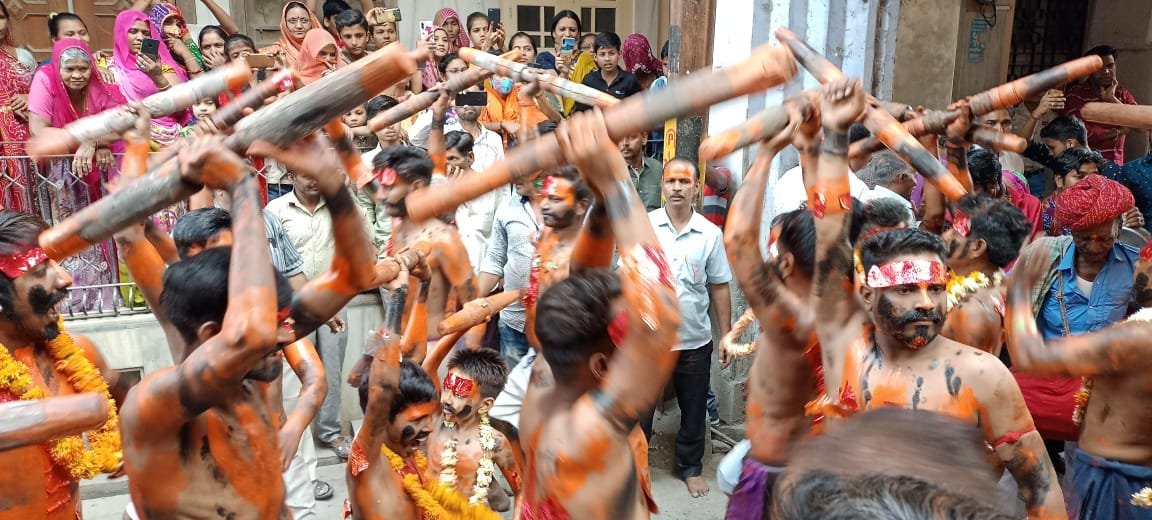 pali/sadri. Bhairav dancing with a pestle in his hands, crowd gathered